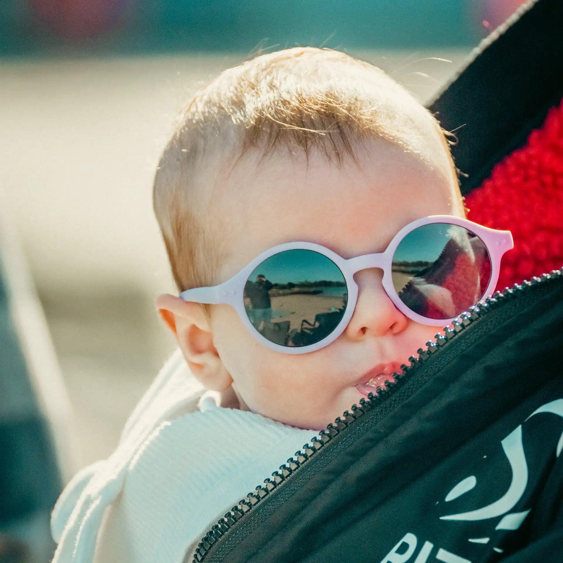 Small baby wearing pink roundabouts