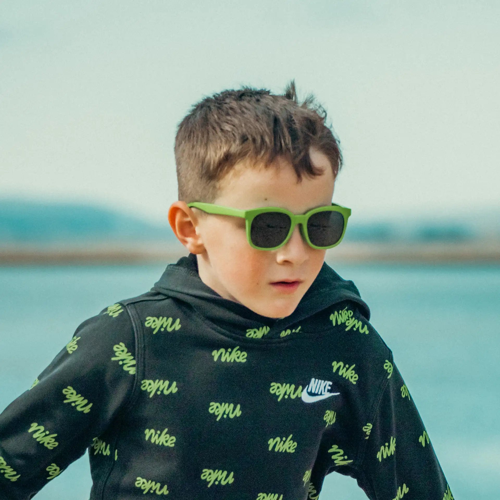 Boy wearing green wayfarers