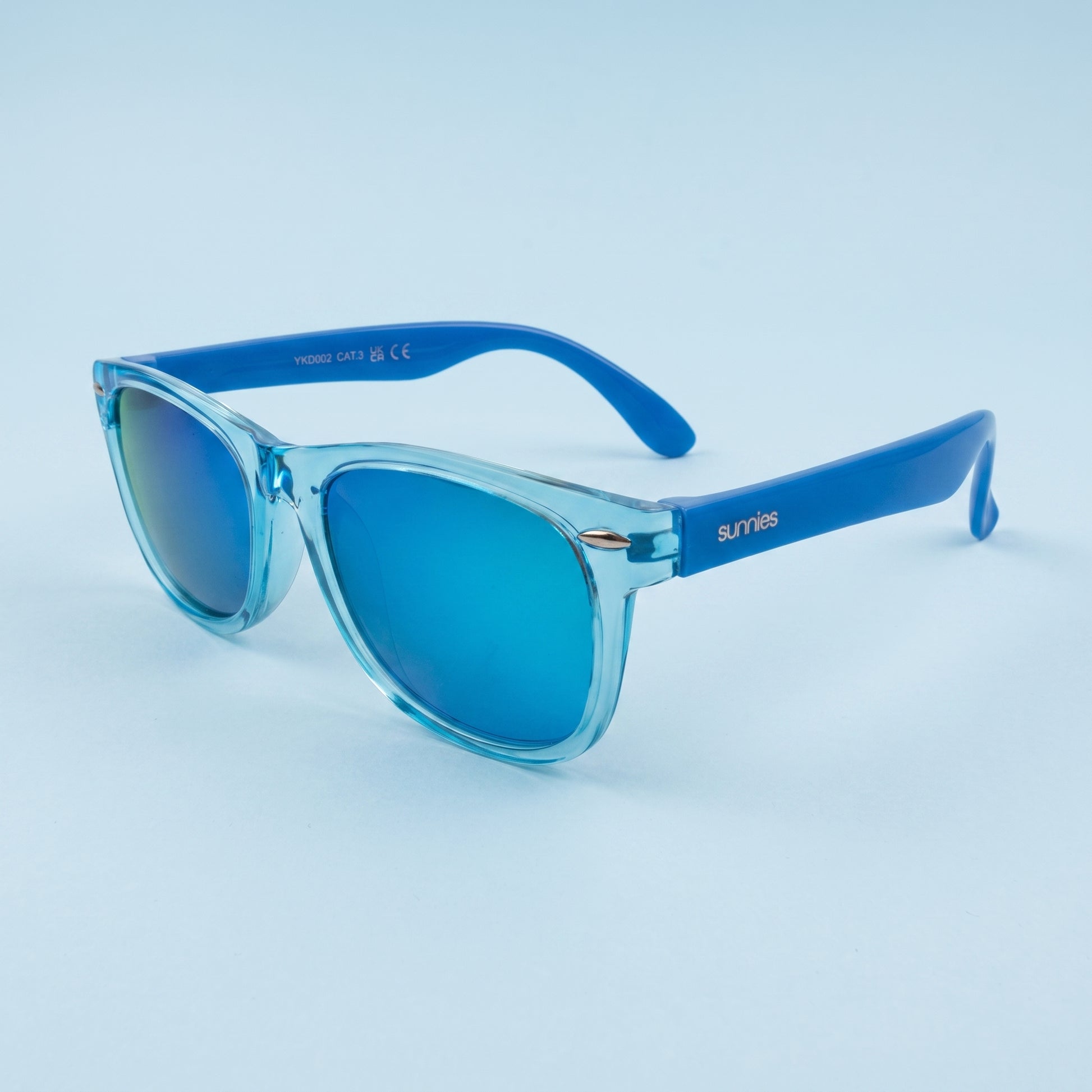 hero: A NEW photorealistic studio photograph composed from scratch, featuring the product as a hero. The product, a pair of children's sunglasses, is placed on a smooth, seamless backdrop in a very light pastel blue color that gently fades into the background. The lighting is provided by broad, soft wraparound diffusion emanating from slightly above and directly in front of the camera, complemented by gentle bounced fill to ensure even tonality and roundness across its form. A single, soft grounding contac…